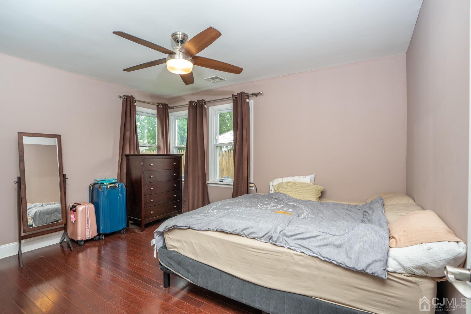24 Kenmore Road Edison, NJ 08817 - Photo 7 of 21 a bedroom with a large bed and a chandelier