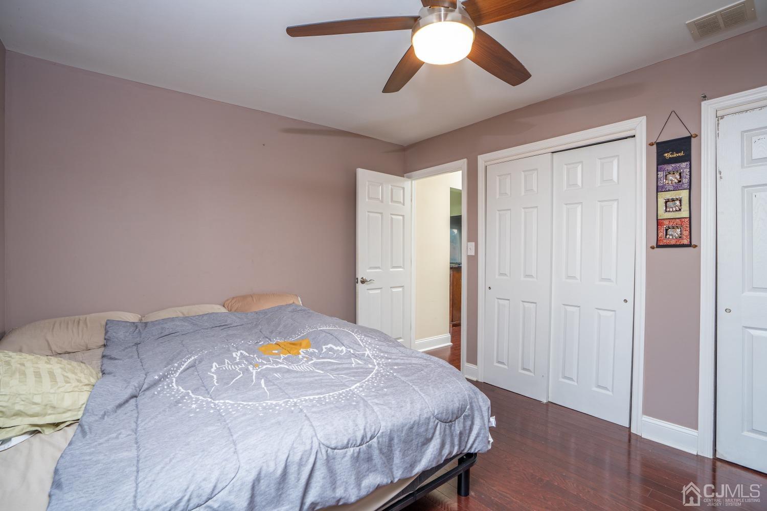 24 Kenmore Road Edison, NJ 08817 - Photo 8 of 21 a bedroom with a bed and a chandelier