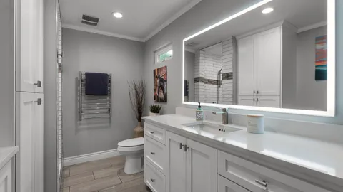 a bathroom with a sink a toilet and shower