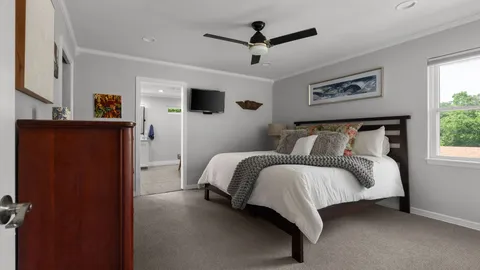 a bedroom with a bed and a ceiling fan