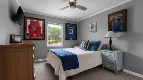 a bedroom with a bed and a painting on the wall