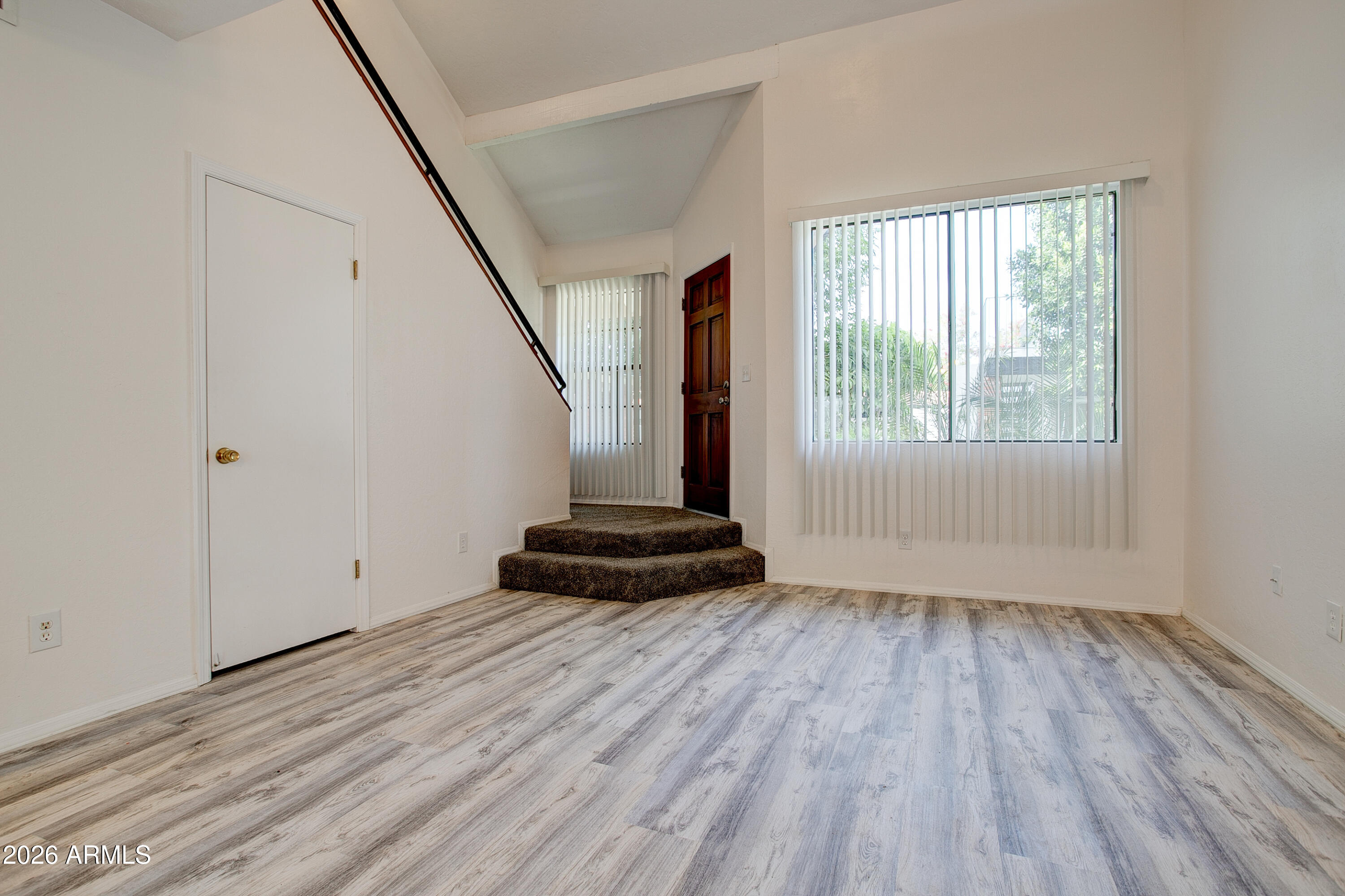 2215 West Augusta Avenue, Unit 102 Phoenix, AZ 85021 - Photo 20 of 39 an empty room with wooden floor and windows