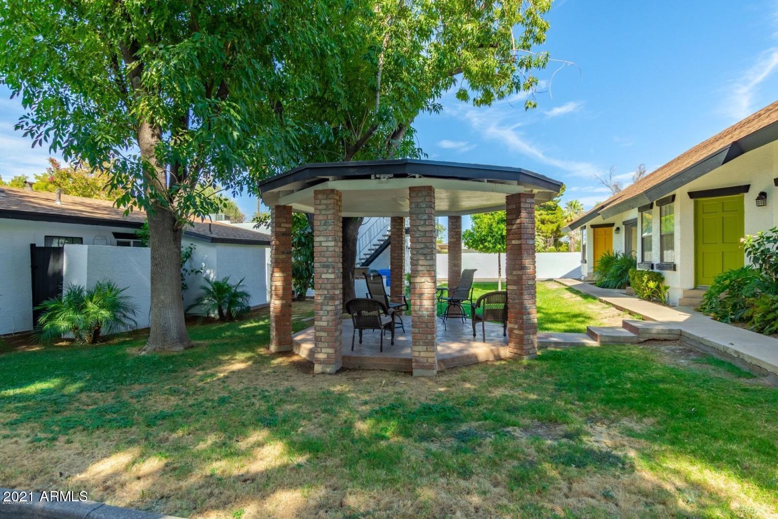 2215 West Augusta Avenue, Unit 102 Phoenix, AZ 85021 - Photo 2 of 39 a view of a chair and table in backyard of a house