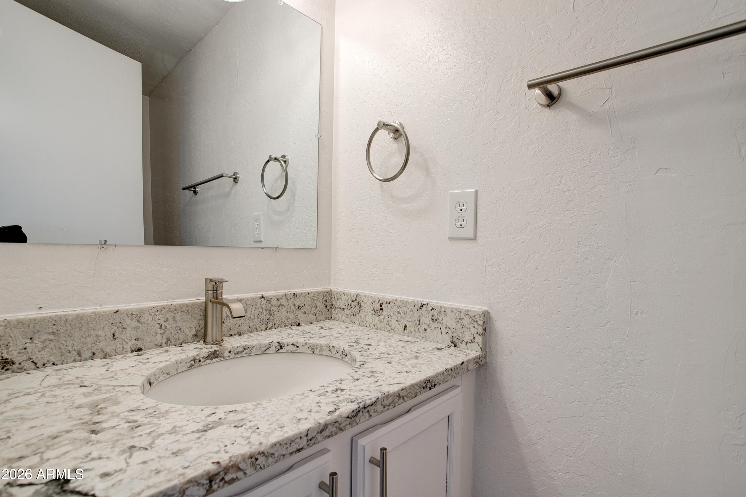 2215 West Augusta Avenue, Unit 102 Phoenix, AZ 85021 - Photo 23 of 39 a bathroom with a granite countertop sink and a mirror