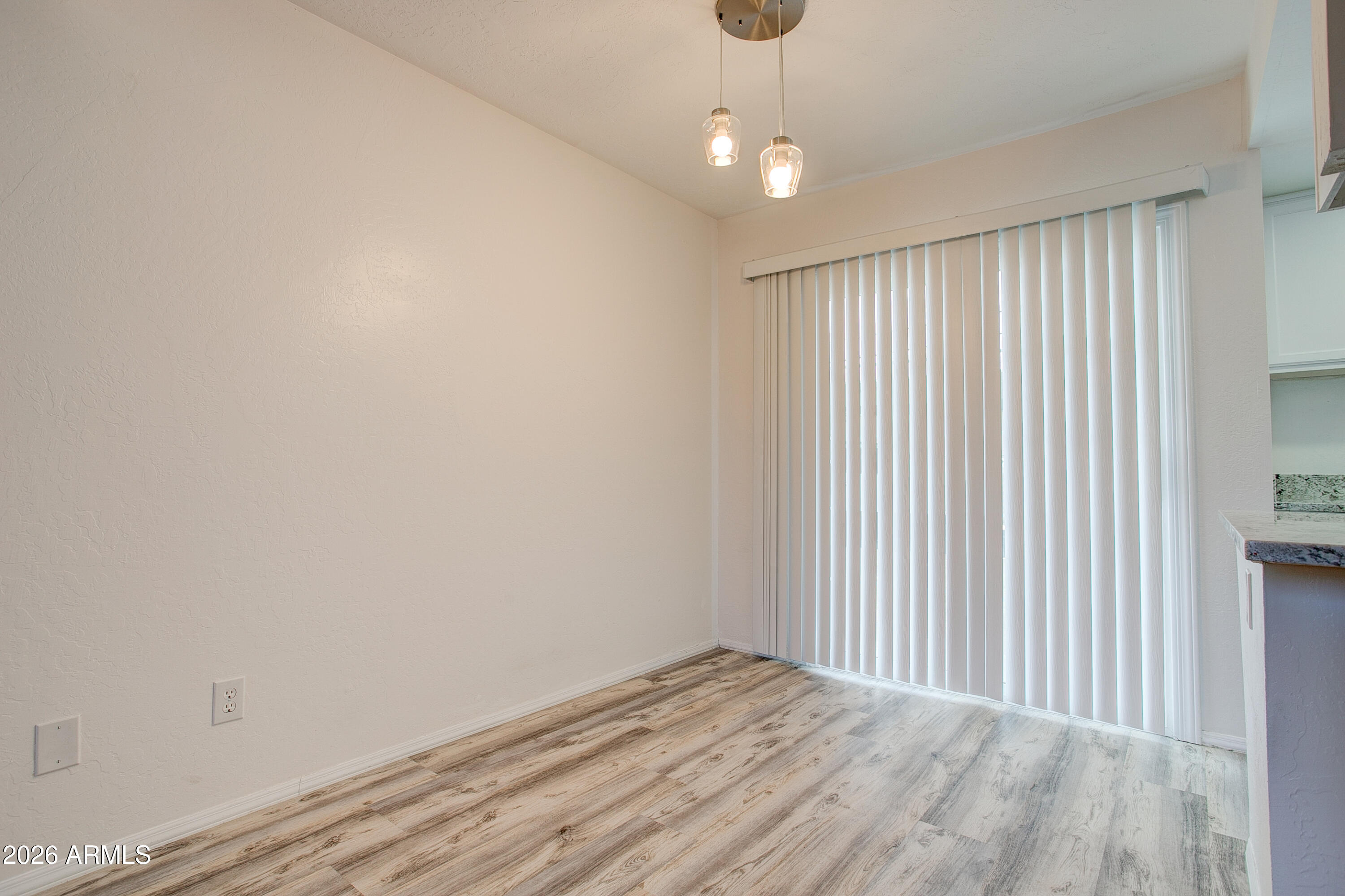 2215 West Augusta Avenue, Unit 102 Phoenix, AZ 85021 - Photo 24 of 39 en empty room with wooden floor fan and window