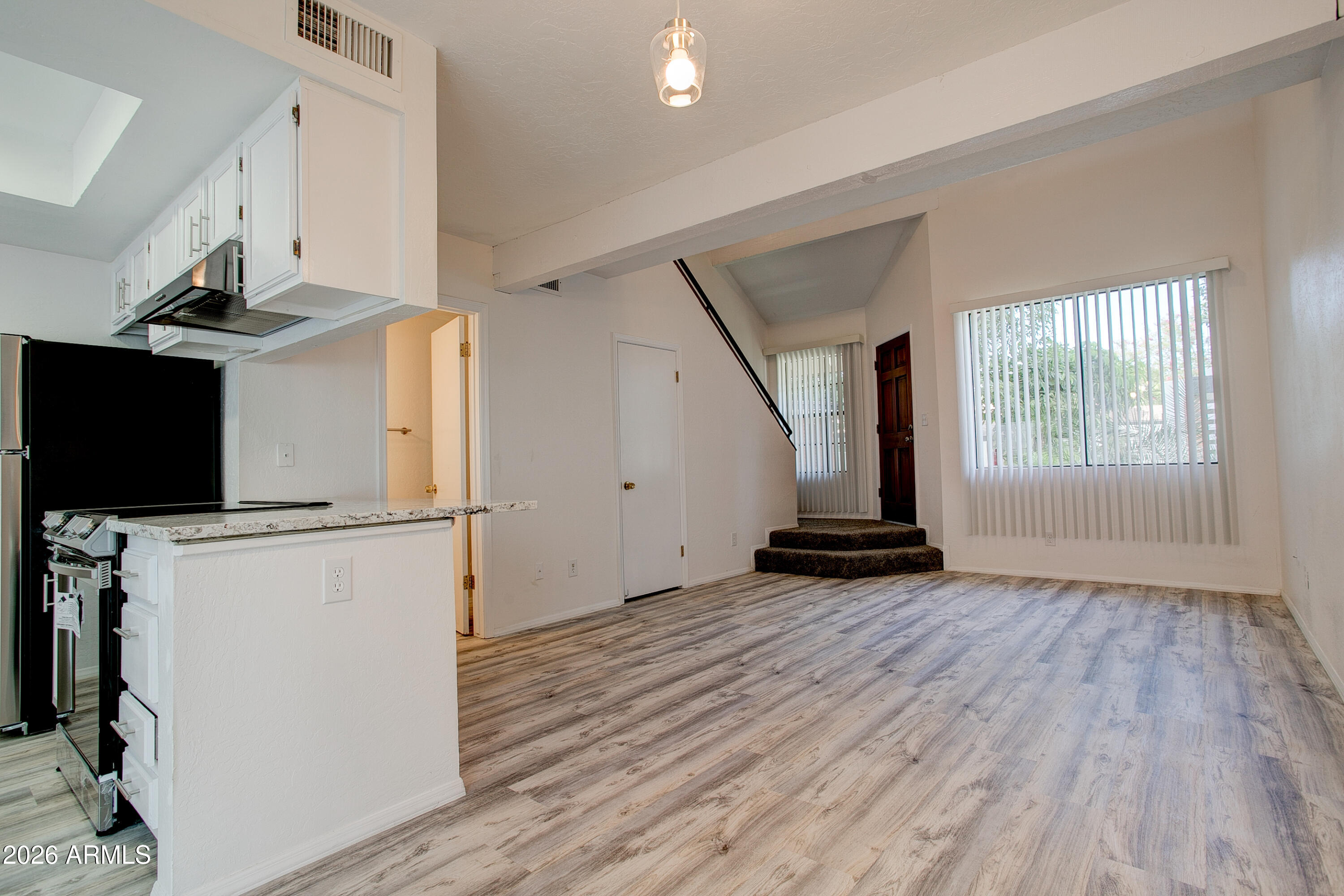2215 West Augusta Avenue, Unit 102 Phoenix, AZ 85021 - Photo 25 of 39 a view of a kitchen with wooden floor and electronic appliances