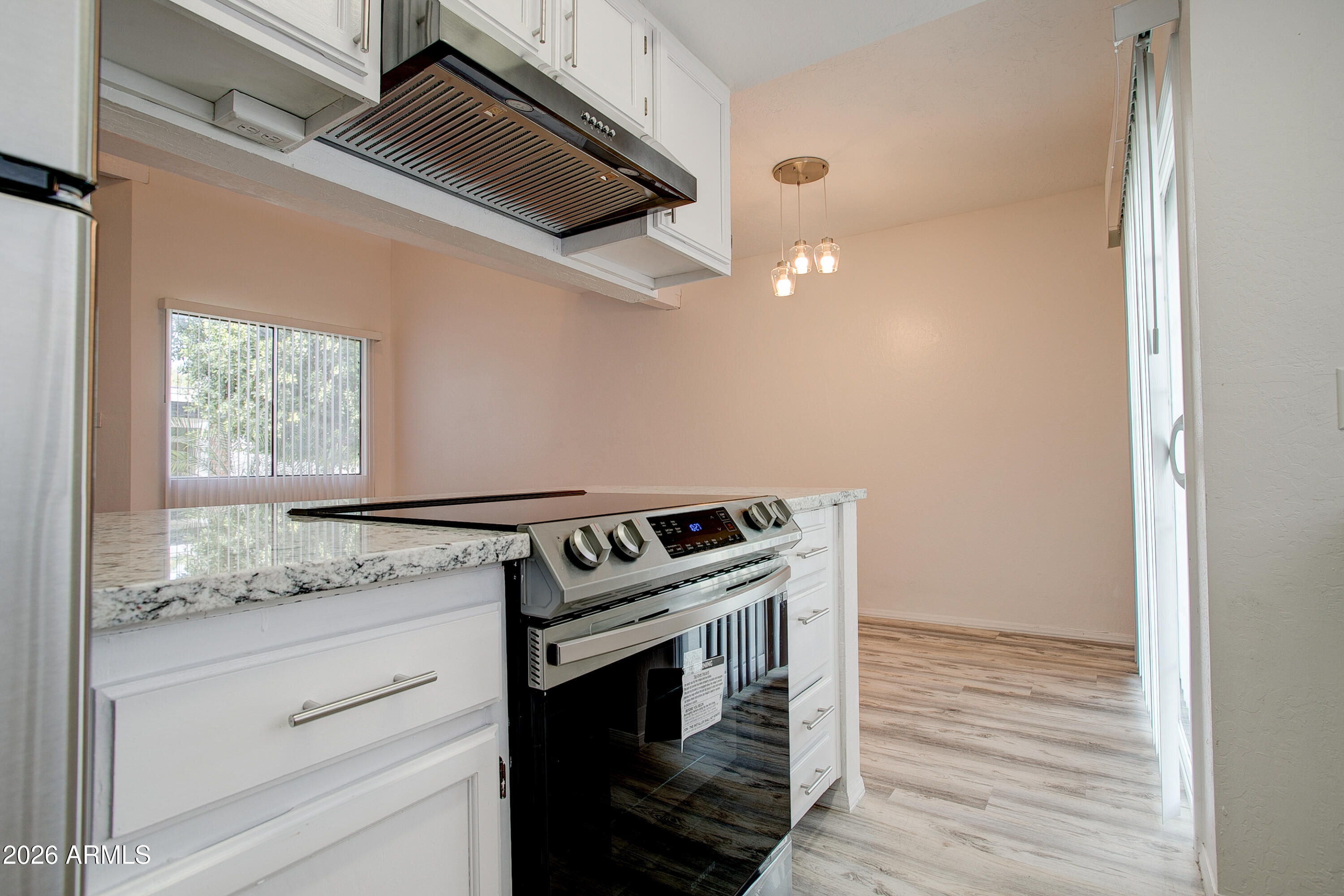 2215 West Augusta Avenue, Unit 102 Phoenix, AZ 85021 - Photo 29 of 39 a kitchen with granite countertop white cabinets and white appliances