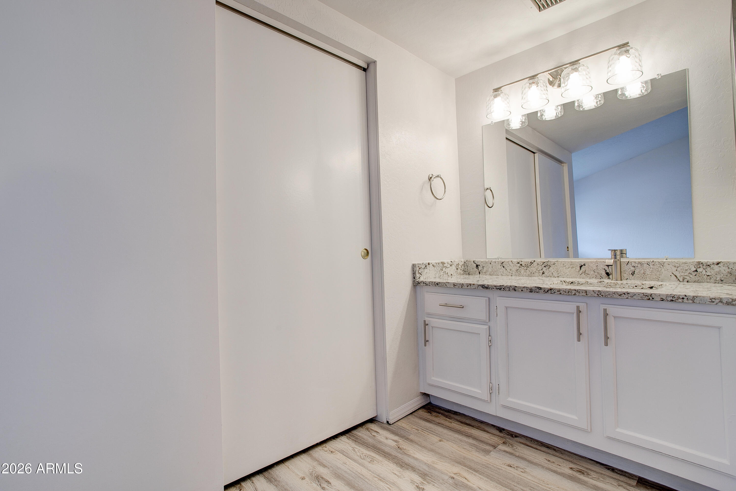 2215 West Augusta Avenue, Unit 102 Phoenix, AZ 85021 - Photo 37 of 39 a bathroom with a granite countertop sink and a mirror
