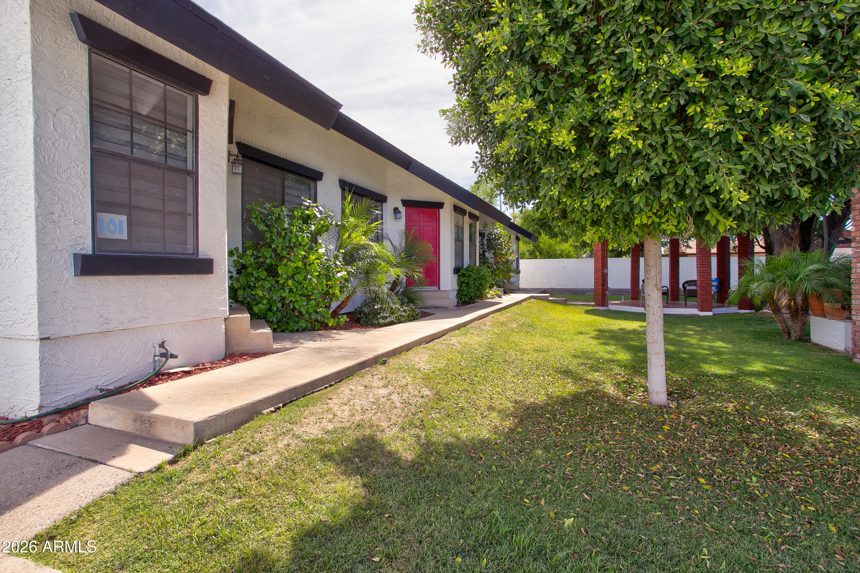 2215 West Augusta Avenue, Unit 102 Phoenix, AZ 85021 - Photo 6 of 39 a view of a house with a yard and tree