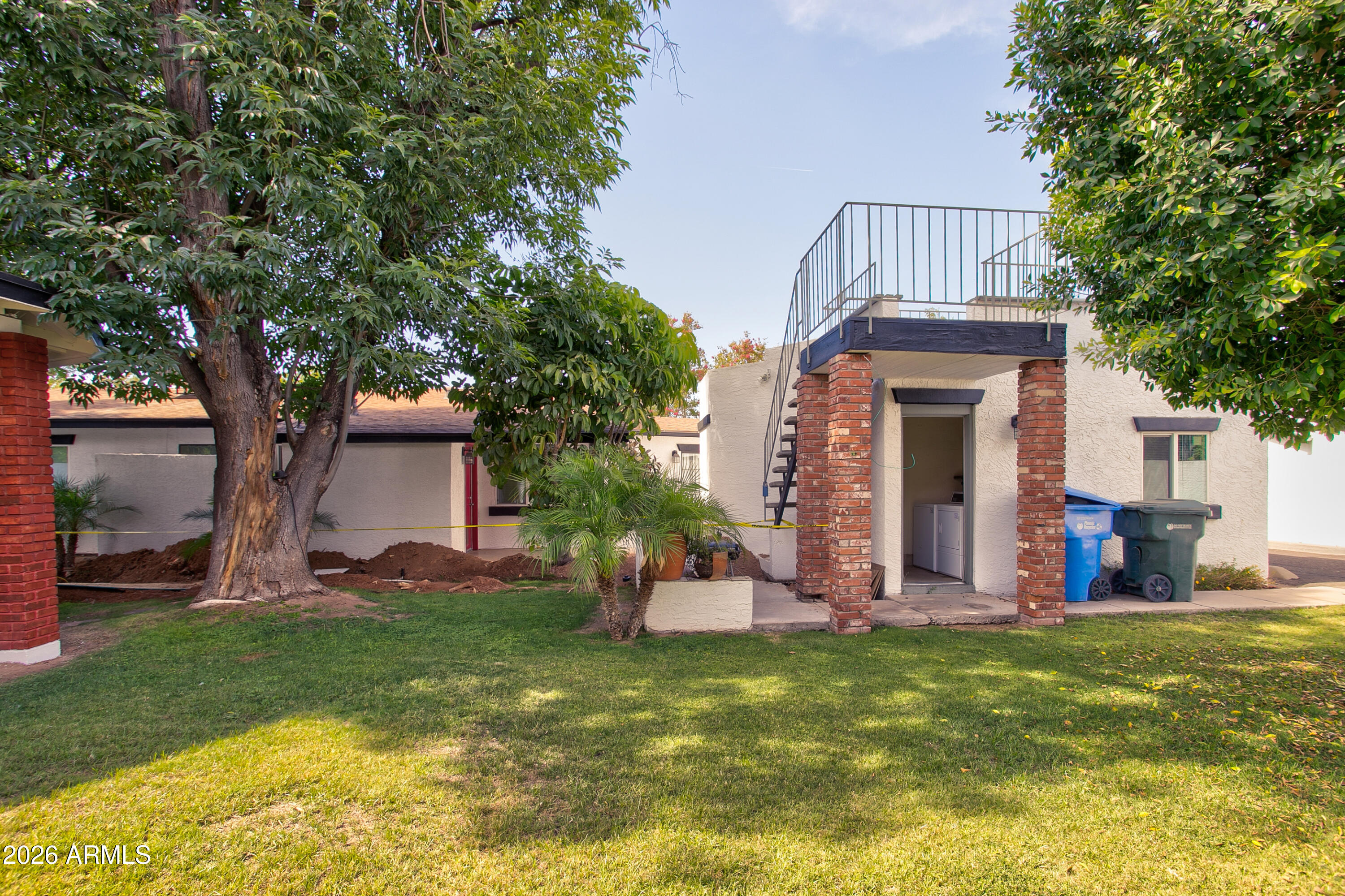 2215 West Augusta Avenue, Unit 102 Phoenix, AZ 85021 - Photo 9 of 39 a front view of a house with garden