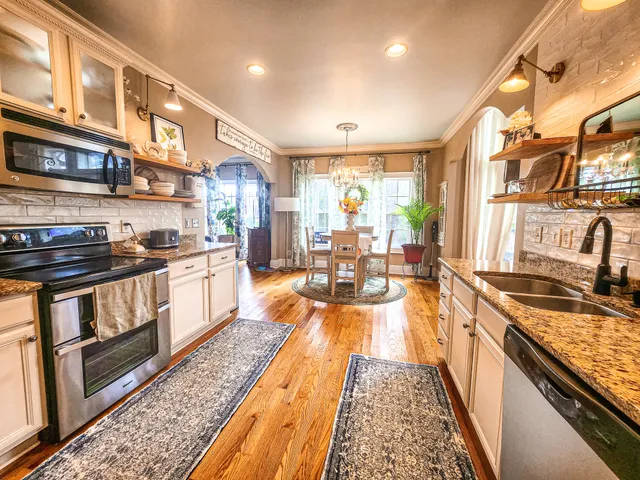 a kitchen with stainless steel appliances granite countertop a stove and a sink