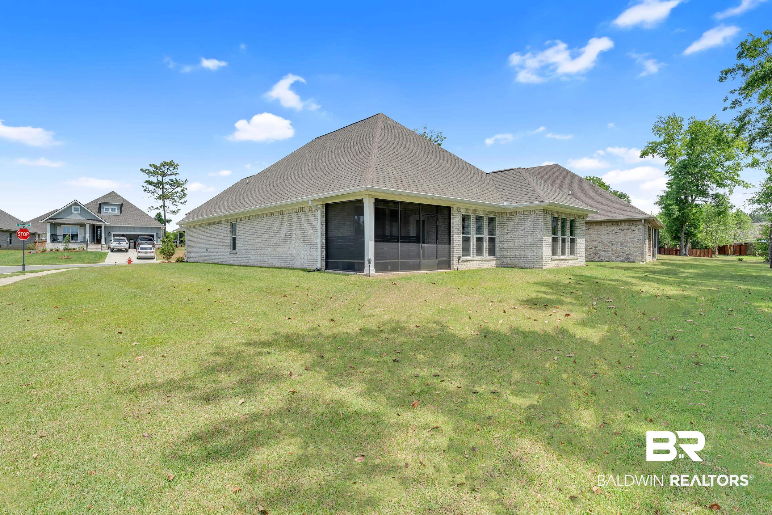 31630 Canopy Loop Daphne, AL 36527 - Photo 24 of 30 Rear view of property featuring a sunroom, a yard, and brick siding