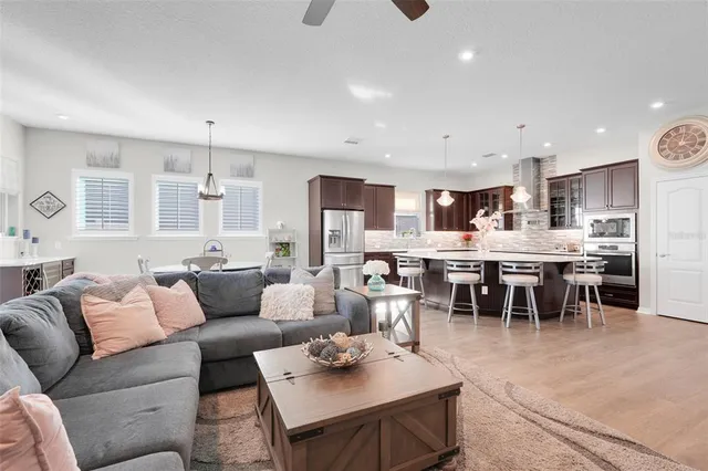 a living room with furniture kitchen view and a dining table