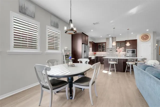 a view of a dining room with furniture and window