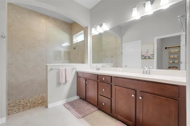 a bathroom with a double vanity sink and a mirror