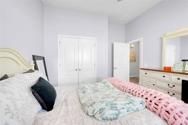 a bedroom with a bed and a dresser in it