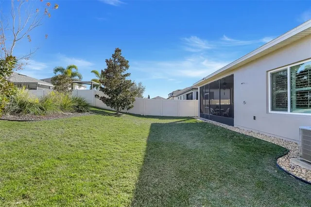 an aerial view of a house with a yard pool patio and outdoor seating