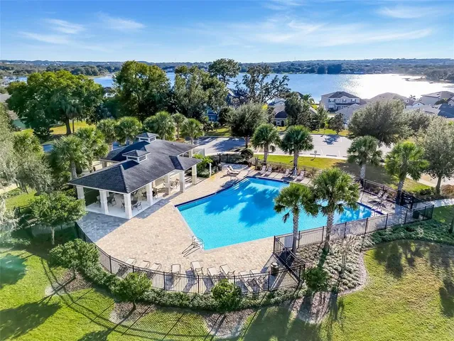 an aerial view of a houses with a swimming pool