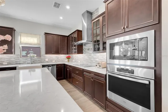 a kitchen with stainless steel appliances granite countertop a stove and a sink