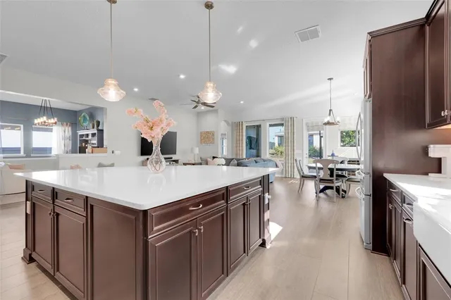 a large kitchen with a center island and stainless steel appliances