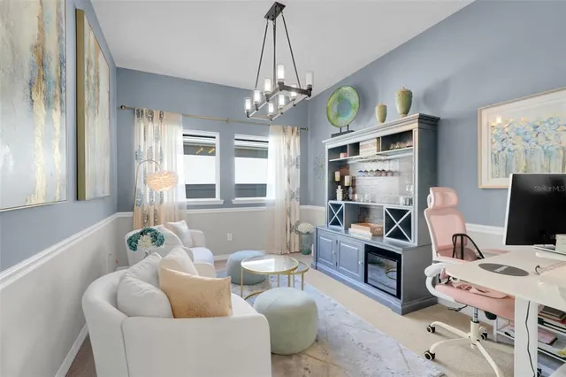 a workspace with furniture and a chandelier