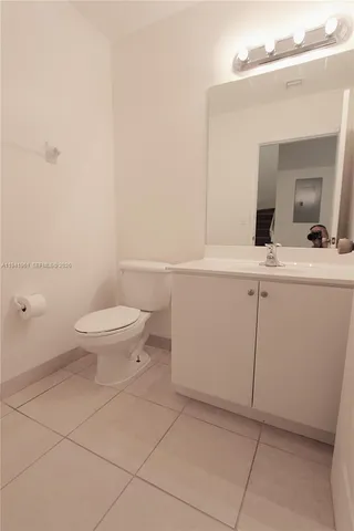 a bathroom with a sink a toilet and mirror