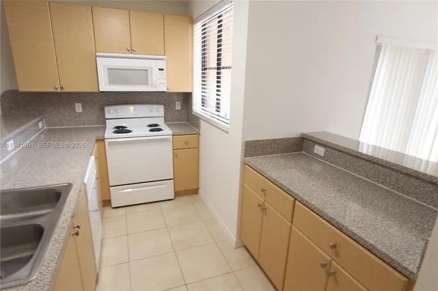 a utility room with sink dryer and washer