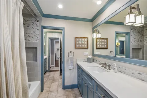 a spacious bathroom with a sink a mirror and a shower