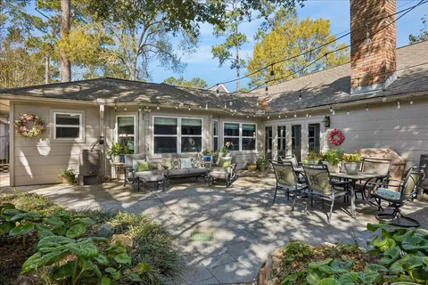 a view of a house with backyard sitting area and garden