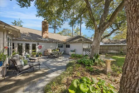 a view of a house with backyard and sitting area