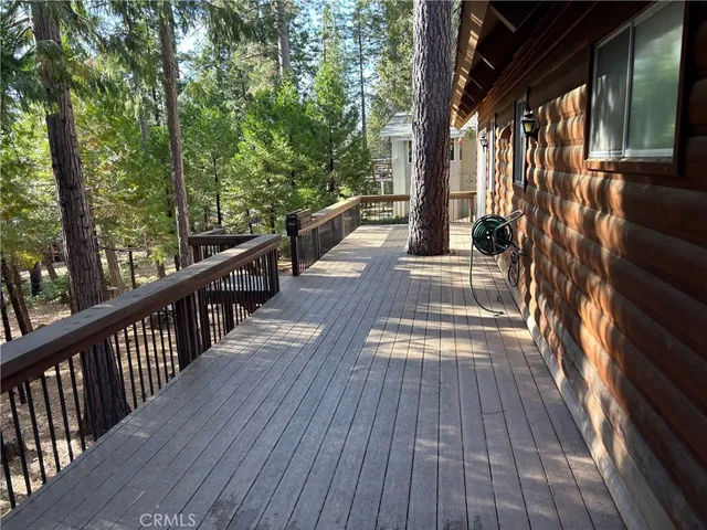 a view of balcony with wooden floor and outdoor seating