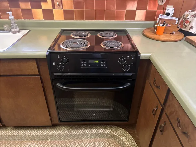 a stove top oven sitting inside of a kitchen