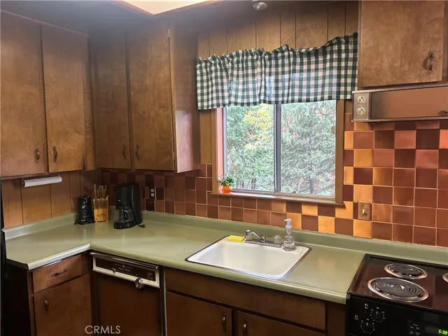 a kitchen with a sink a stove and a microwave