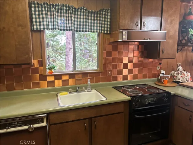 a kitchen with a sink stove and cabinets