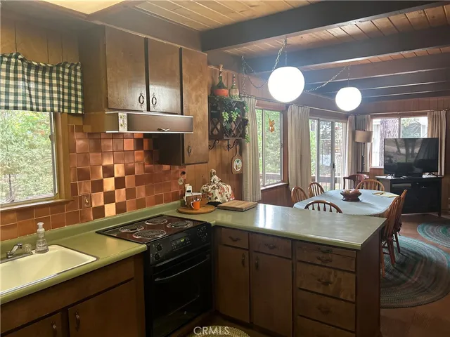 a kitchen with a sink stove and cabinets