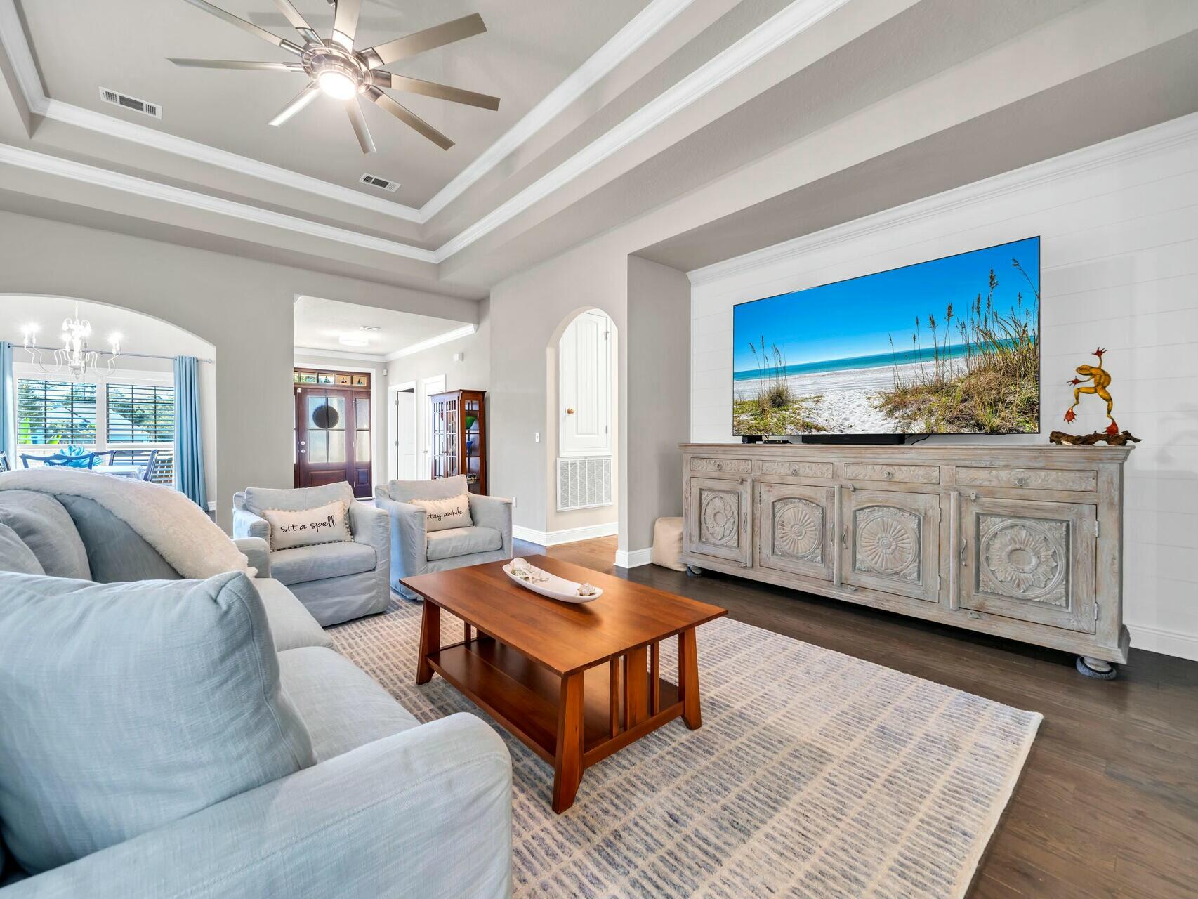 188 Ocean Spray Circle Santa Rosa Beach, FL 32459 - Photo 20 of 75 a living room with furniture a rug and a chandelier