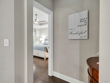 a kitchen with stainless steel appliances kitchen island granite countertop a refrigerator a stove a oven with white cabinets and chairs