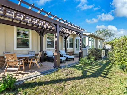 a view of swimming pool with a table and chairs under an umbrella
