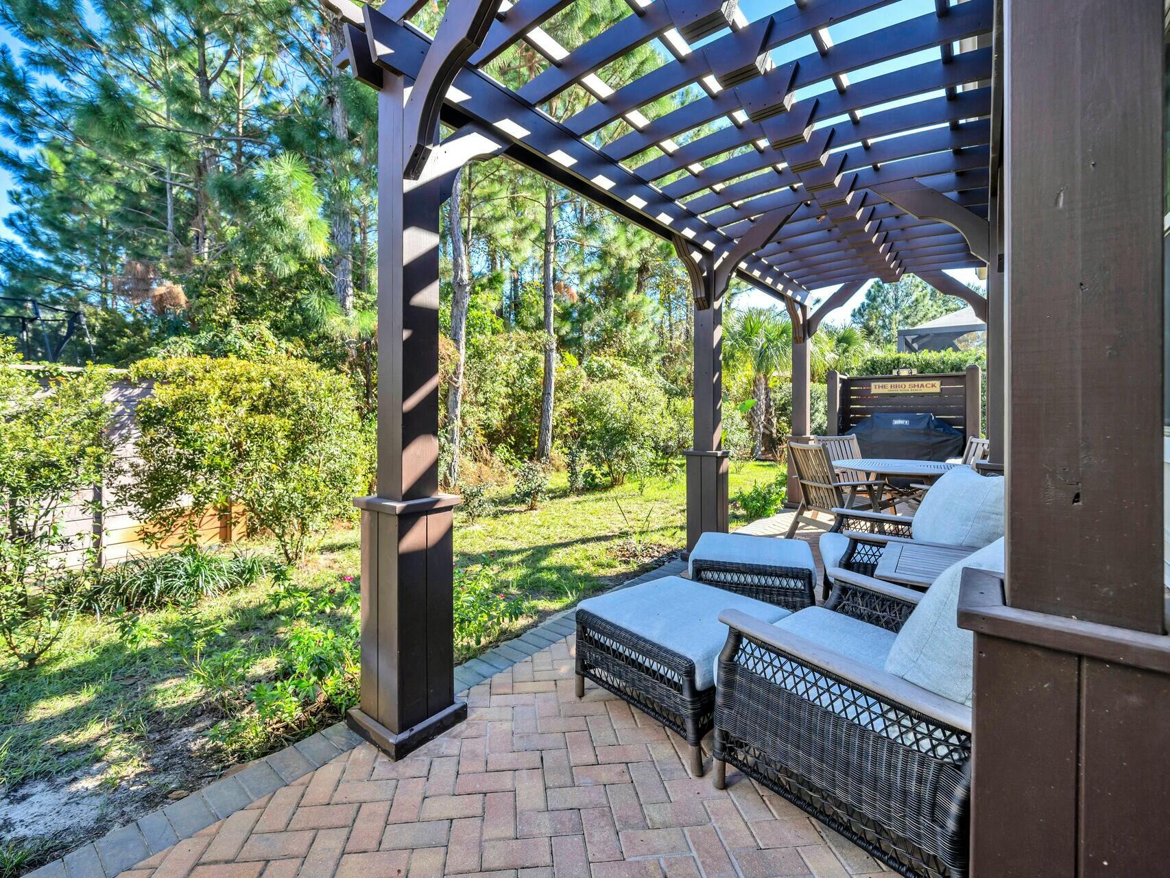 188 Ocean Spray Circle Santa Rosa Beach, FL 32459 - Photo 50 of 75 a view of a patio with a table chairs and a backyard
