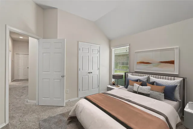 a bedroom with a bed and a painting on the wall