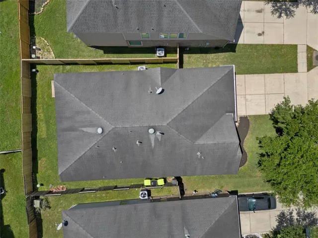 an aerial view of a house with a yard