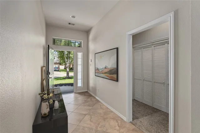 a view of hallway with a potted plant and a window