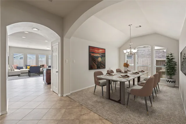 a view of a dining room with furniture and chandelier