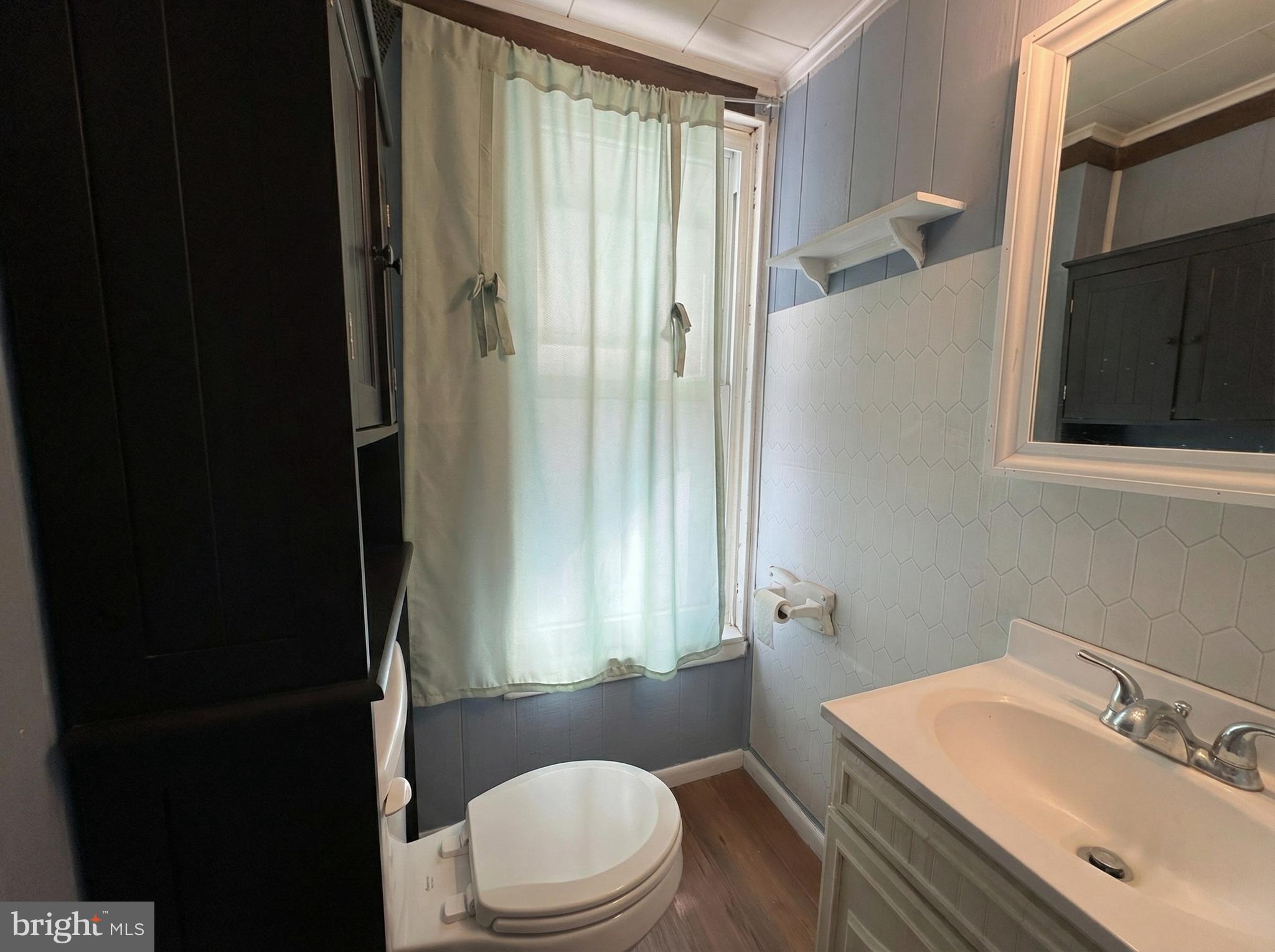 151 Arch Street York, PA 17401 - Photo 11 of 15 a bathroom with a sink a toilet and shower