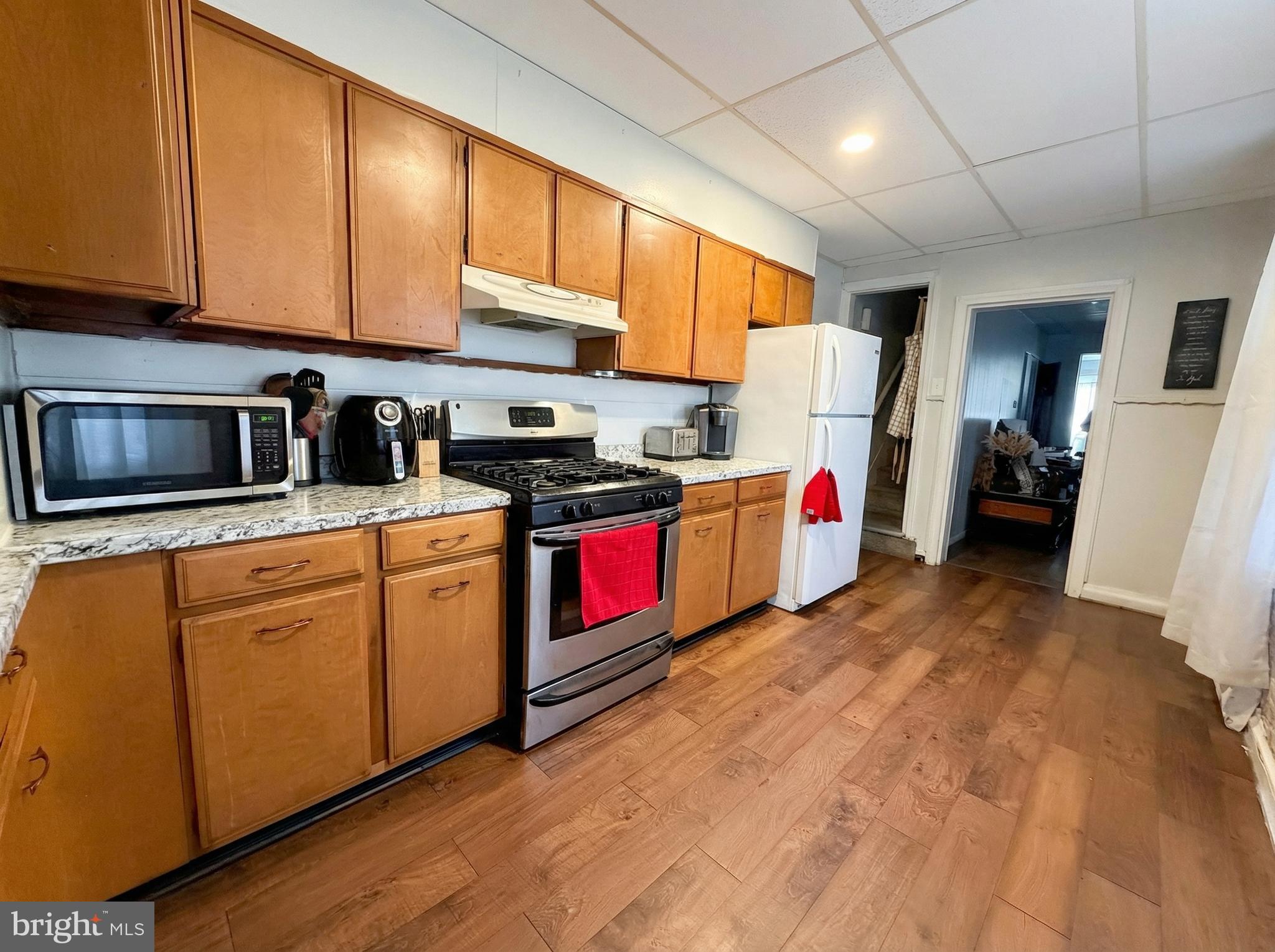 151 Arch Street York, PA 17401 - Photo 15 of 15 a kitchen with stainless steel appliances granite countertop a stove sink and refrigerator