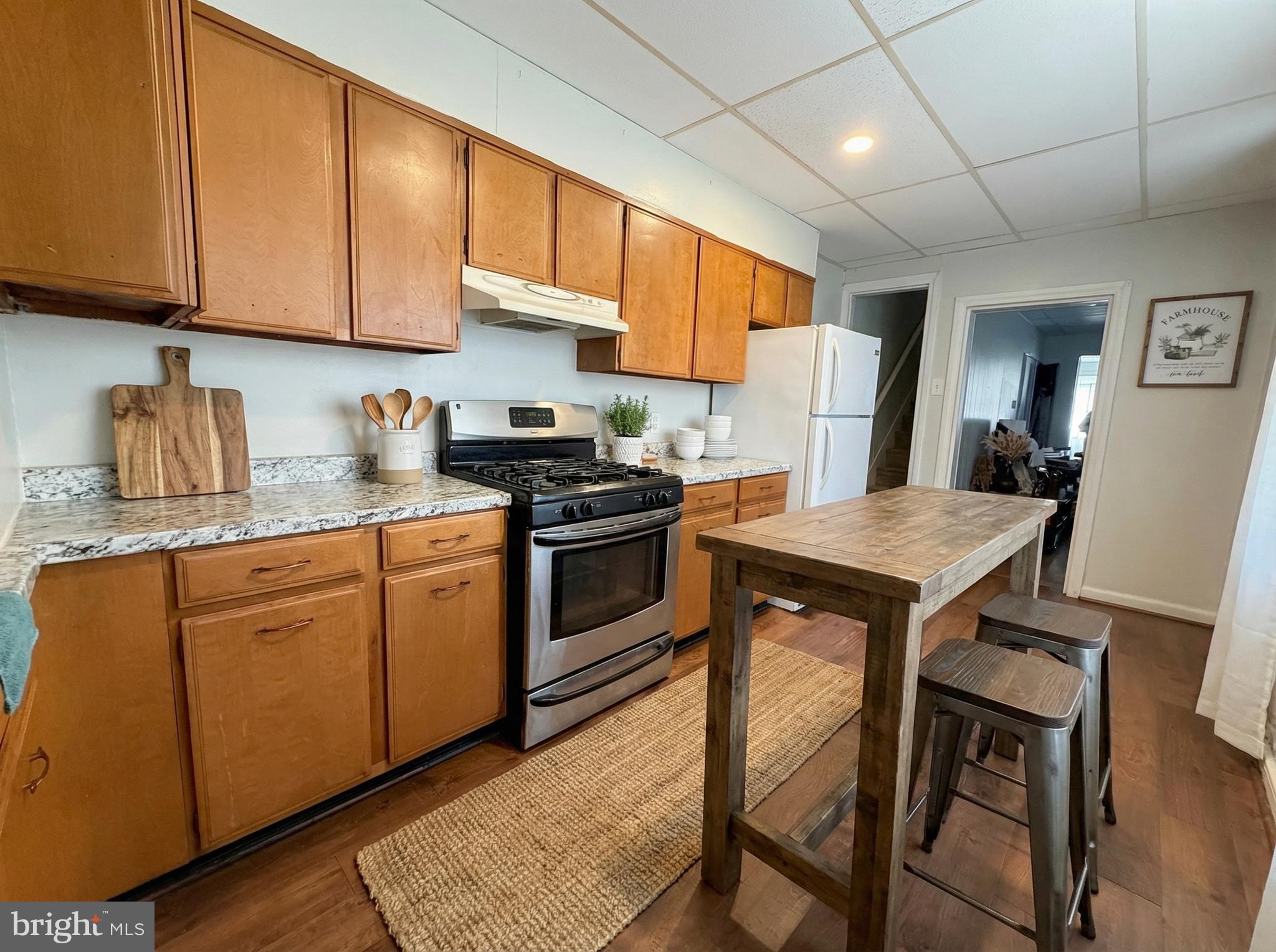 151 Arch Street York, PA 17401 - Photo 6 of 15 a kitchen with a stove a sink a refrigerator and cabinets