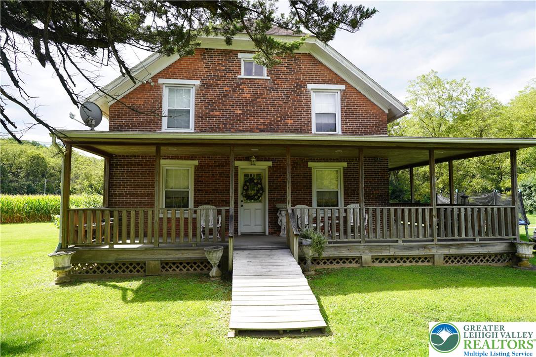 3065 Quarry Street Coplay, PA 18037 - Photo 5 of 19 a view of a house with a yard deck and a large tree