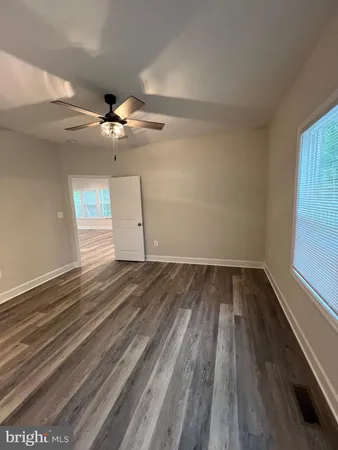 a view of walk in closet with wooden floor