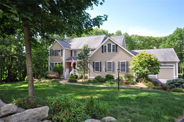 71 Chamberlain Road Westford, MA 01886 - Photo 1 of 30 a front view of a house with a yard and trees
