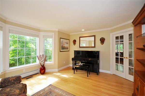 71 Chamberlain Road Westford, MA 01886 - Photo 12 of 30 a living room with furniture and a flat screen tv with kitchen view